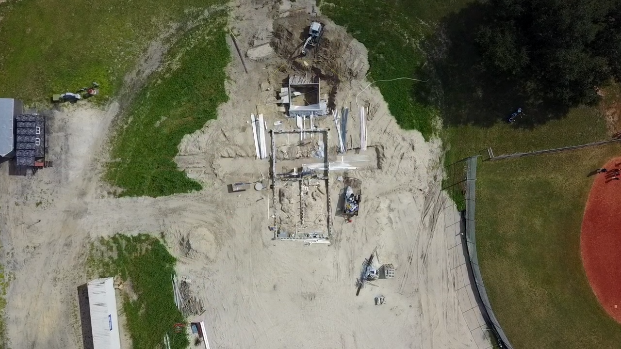 Aerial photo of an early-stage residential construction site next to a Florida ballfield
